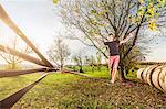 Portrait of young man walking on slackline