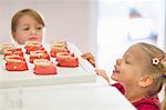 Two girls looking at false teeth