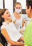 Woman having check up with dentist and dental nurse