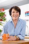 Portrait of youthful senior woman in kitchen