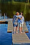 Two male adult friends strolling on pier, Gavle, Sweden