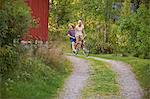 Young adult couple having fun on bicycle, Gavle, Sweden