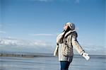 Young woman with arms out, Brean Sands, Somerset, England