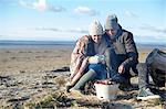 Young couple having bbq on beach, Brean Sands, Somerset, England