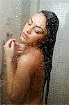 Young woman with eyes closed enjoying a shower