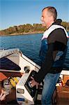 Smiling man with dog on boat, Ronneby, Blekinge, Sweden