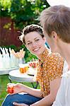 Woman and man talking at garden party