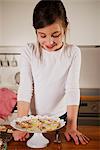 Girl looking at Christmas cookies, Munich, Bavaria, Germany