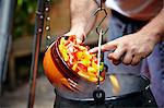 Person Adding Vegetable In Cooking Pot