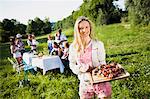 Friends barbecuing on the riverside, foothills of the Alps, Bavaria, Germany