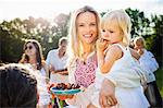 Family with children barbecuing on the riverside, foothills of the Alps, Bavaria, Germany