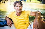 Man relaxes on the riverside, portrait, foothills of the Alps, Bavaria, Germany