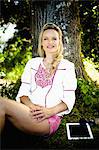 Young woman leaning against tree, foothills of the Alps, Bavaria, Germany