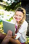 Young woman looking at tablet PC outdoors, foothills of the Alps, Bavaria, Germany