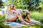 Young couple relaxes on the riverside, foothills of the Alps, Bavaria, Germany