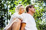 Young couple relaxes on the riverside, foothills of the Alps, Bavaria, Germany