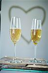 Champagne flutes against heart shape on wall, Munich, Bavaria, Germany