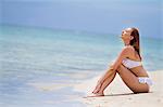 Young woman in bikini relaxes on beach, Lankayan Island, Borneo, Malaysia