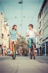 Young couple riding bicycles together, Osijek, Croatia