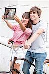 Young couple taking self portrait with digital tablet, Osijek, Croatia