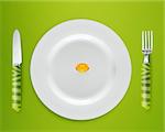 Cod Liver oil on white plate with knife and fork on blue background.