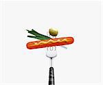 close up of  hotdog olive and green onion leaf  pierced by fork,  isolated on white background