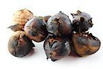 roasted sweet chestnuts on white background.