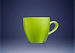 Green tea mug or cup on blue background.