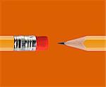 Sharpened Yellow pencil on orange background.