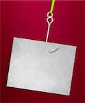 Blank sheet of paper hanging on a fishing hook on red background