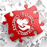 Charity Word Written Arround Icon of Heart in the Hand, Located on Red Puzzle. Social Concept.