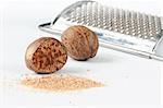 A closeup of nutmegs and a grater.
