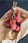 A bunch of Lychees on a paper bag ready to eat