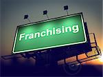 Franchising - Green Billboard on the Rising Sun Background. .