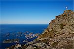 Picturesque fishing town of Henningsvaer with mountain Festavagtinden, popular climbing spot on Lofoten islands in Norway