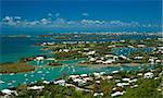 A aerial view of the Great Sound of Bermuda, with white roofed buildings and the ocean