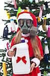 Young girl with her plastic christmas present - environmental concept, isolated