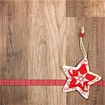 Christmas decoration with wood background, Christmas star red with ribbon