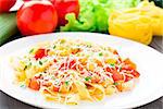 Fettuccine with tomato on a white plate