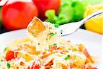 Delicious fettuccine with tomato on a fork