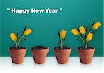 Happy new year 2014, Group of yellow tulips in clay container.