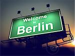 Welcome to Berlin - Green Billboard on the Rising Sun Background.