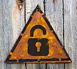 Security Concept. Icon of Opened Padlock on Weathered Triangular Yellow Warning Sign. Grange Background.
