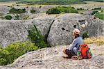 Hiking man having rest at the top of Eski Kermen, Crimea, Ukraine