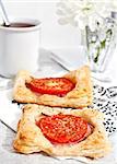 Breakfast with tomato tarts and cup of coffee