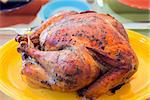Cooked Roast Turkey on Yellow Platter for Thanksgiving Dinner