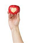 adult man hand holding apple with carved heart, isolated on white
