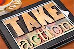 take action - motivation concept -  text in vintage letterpress wood type on a digital tablet