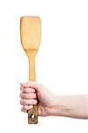 Hand holding old wooden kitchen spatula isolated on white