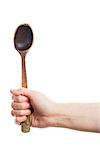 Hand holding old wooden spoon isolated on white